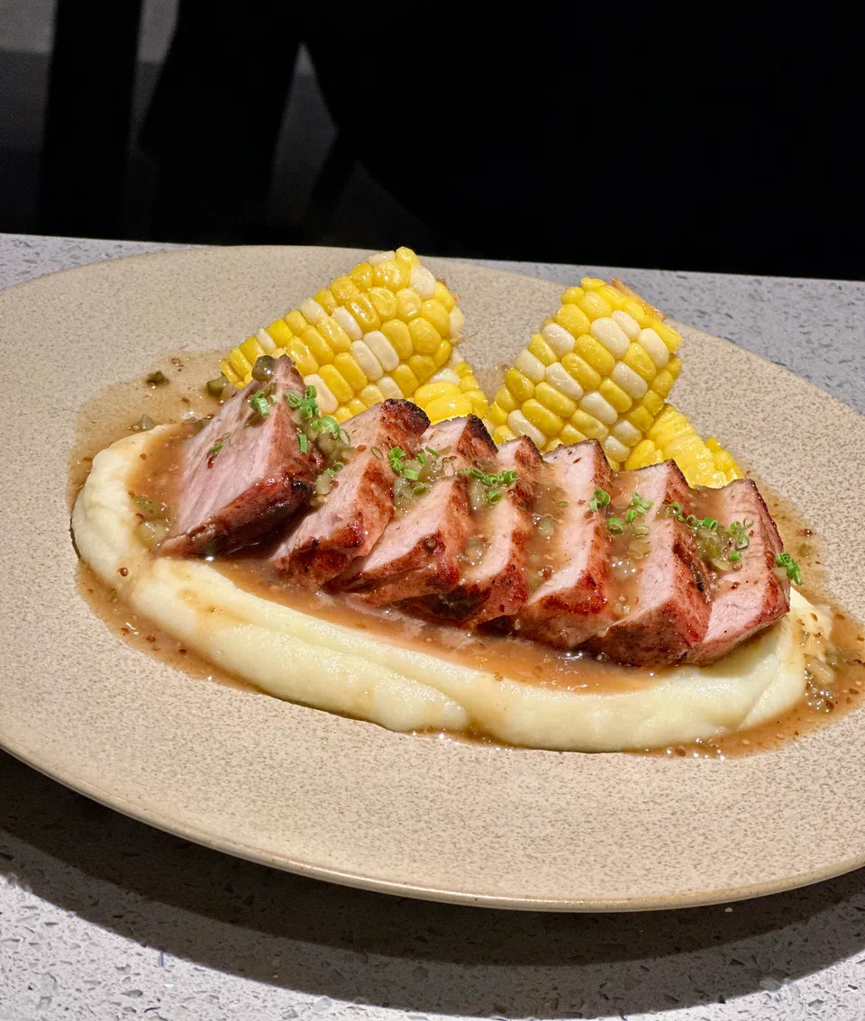 A rack of Iberico pork with mashed potatoes and sweetcorn.