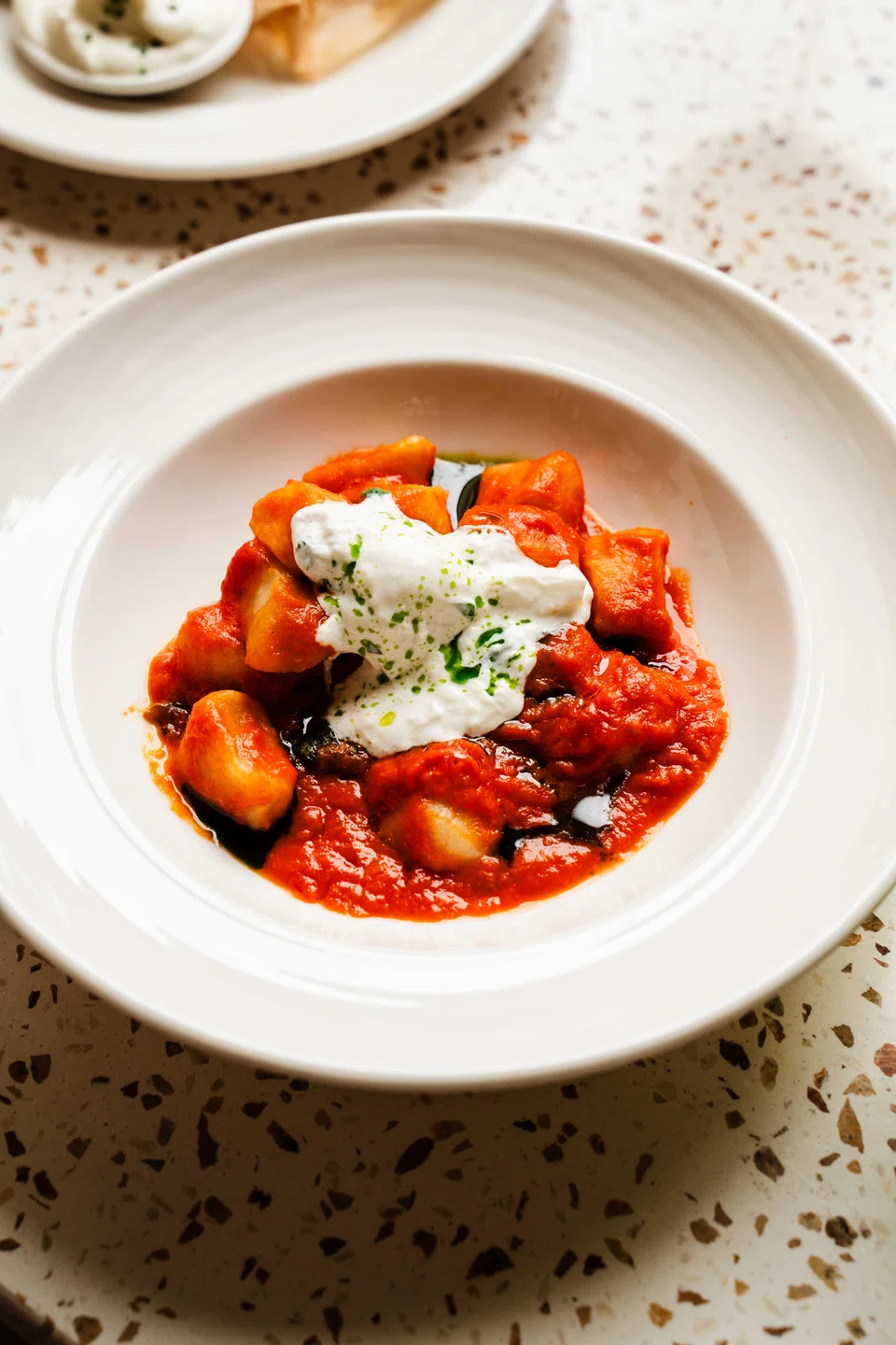 Classic gnocchi in tomato sauce with stracciata cheese.