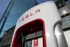The Tesla logo is seen through a charging station outside a store of the electric vehicle (EV) maker in Beijing, China January 4, 2024. REUTERS/Florence Lo