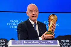 Gianni Infantino with the World Cup trophy in Davos, Switzerland.  The Fifa president has defended the sky high ticket prices, citing unprecedented demand and the revenue generated for football around the world. 