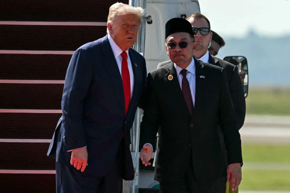 US President Donald Trump (left) speaking with Malaysia's Prime Minister Anwar Ibrahim at the foot of the stairs of Air Force One upon his arrival at Kuala Lumpur International Airport.
