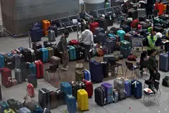 IndiGo staff tagging stranded bags and belongings of passengers following large-scale flight disruptions at New Delhi's Indira Gandhi International Airport on Dec 8.