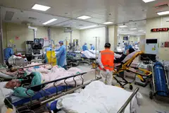 Chinese hospitals and funeral homes were under intense pressure as a surge of new Covid-19 cases drained resources. 