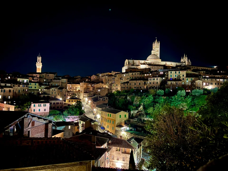 A panorama of Siena’s historic centre – a UNESCO world heritage sight characterised by its distinctive Gothic architectural style – viewed from the Basilica of San Domenico.