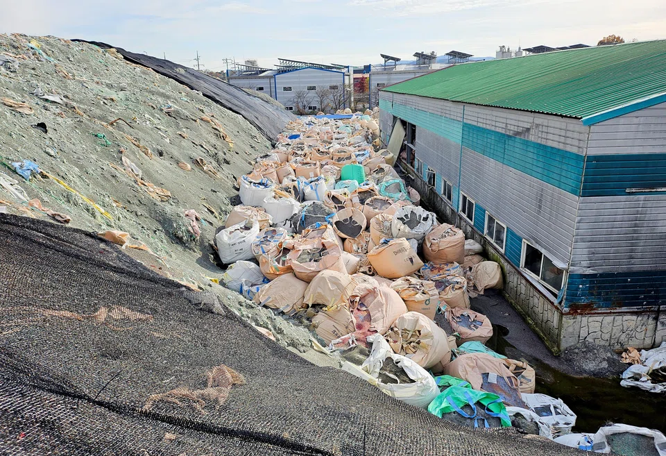 Sacks of untreated and shredded plastic waste, which is left unattended, are piled at an inoperational recycling site in Asan, South Korea, Nov 19, 2024.