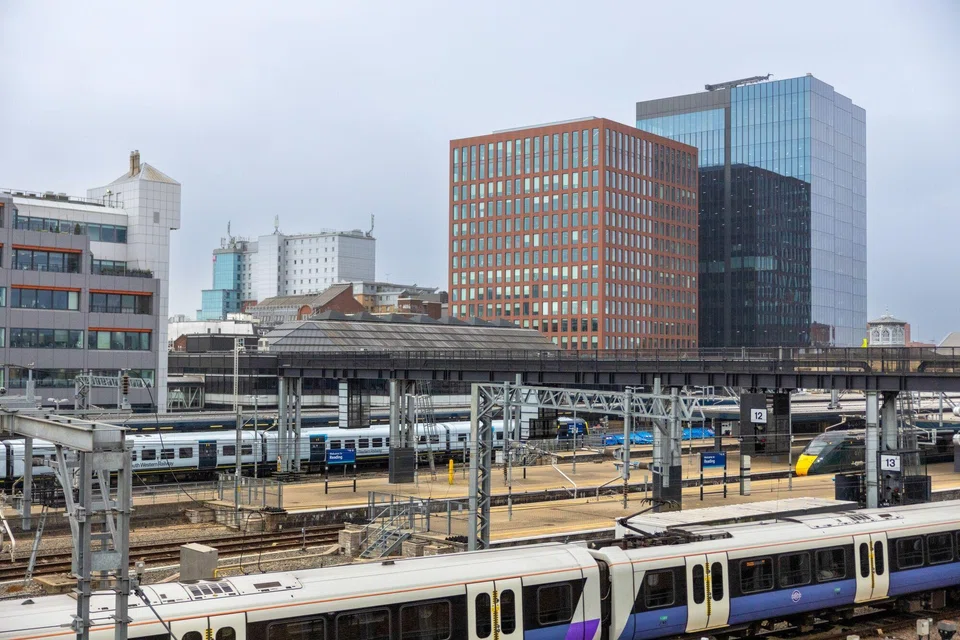 Commuter trains arriving at the Reading railway station, in view of the Thames Tower and One Station Hill office developments. One Station Hill, the largest ever speculative project in the history of the Thames Valley, is about 70% pre-let after completing at the end of last year.