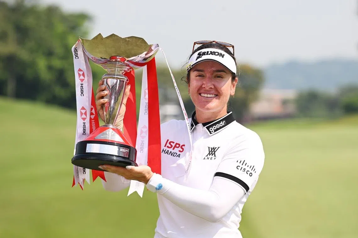 SINGAPORE, SINGAPORE - MARCH 01: Hannah Green of Australia celebrates with the trophy on the 18th green after winning during Day Four of the HSBC Women's World Championship 2026 at Sentosa Golf Club on March 01, 2026 in Singapore, Singapore. (Photo by Ross Kinnaird/Getty Images)