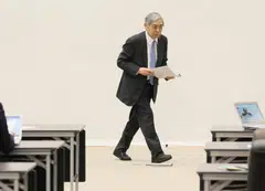 The review warned that the negative effects of former governor Haruhiko Kuroda’s massive monetary stimulus  may last longer than expected and become bigger in the future.