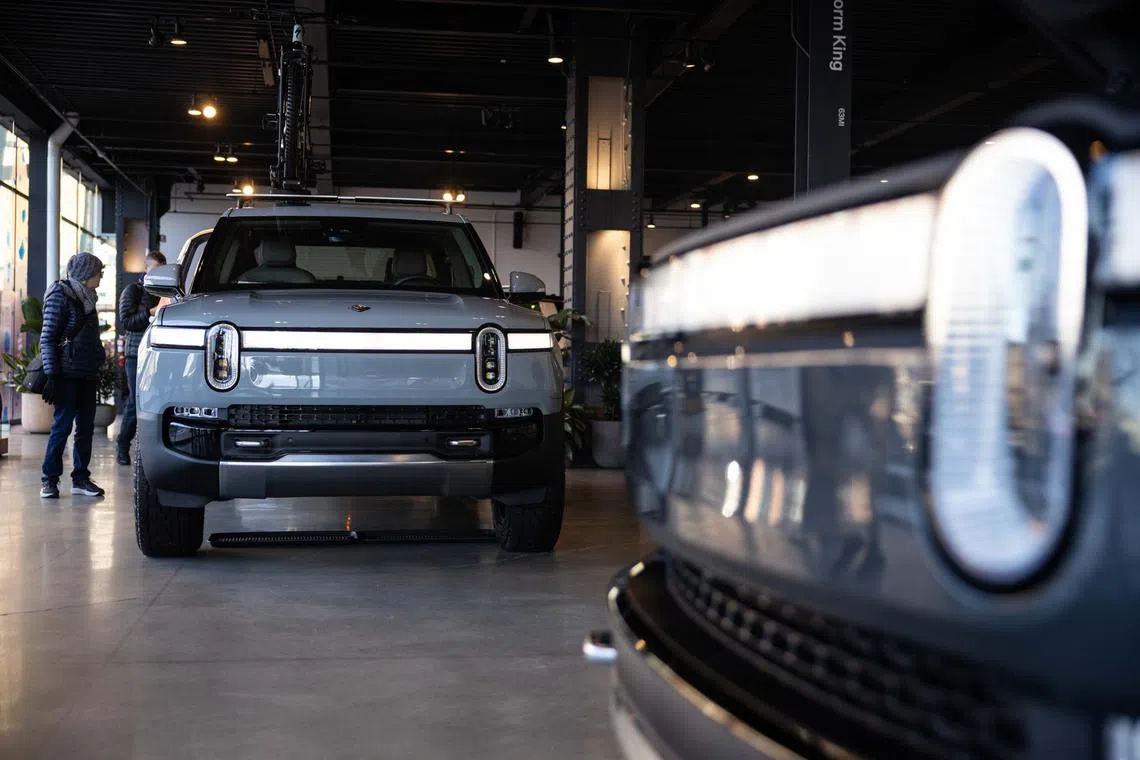 Rivian says it expects to sell between 46,000 and 51,000 EVs this year, below the roughly 54,800 average of analyst estimates compiled by Bloomberg.
