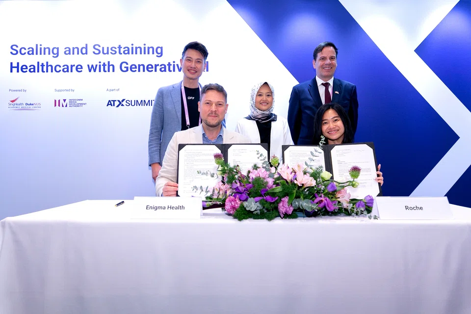 At the signing of the MOU between Enigma Health and Roche were (seated, from left): Dr Dario Heymann, CEO, Enigma Health; and Yeoh Ying Ying, general manager of the pharmaceuticals division at Roche. In the back row are (from left): Associate Professor Daniel Ting, AI office director at SingHealth; Rahayu Mahzam, minister of state for digital development and information; and Frank Grutter, Ambassador of Switzerland to Singapore. 
