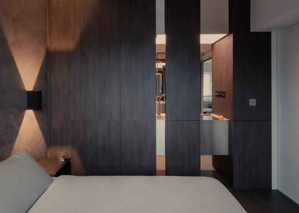 The bedroom is a compact, moody space.