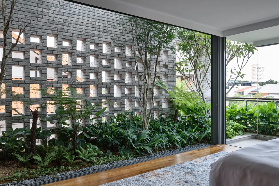Perforated brick walls in the master bedroom provide both privacy and airflow.