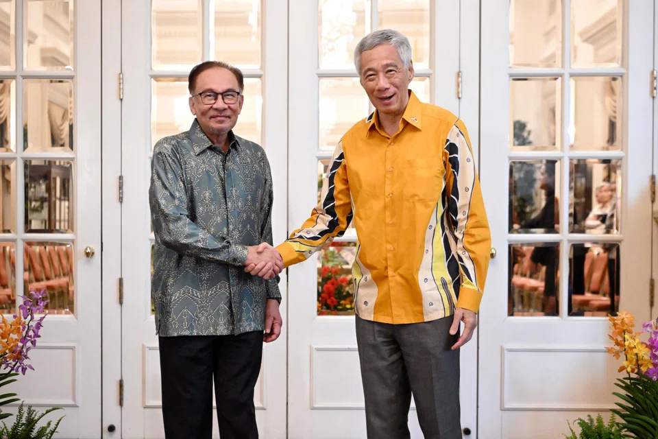 Malaysian Prime Minister Anwar Ibrahim (left) with Prime Minister Lee Hsien Loong at the Istana during the 10th Singapore-Malaysia Leaders' Retreat, where the two countries signed memoranda of understanding to further cooperation.