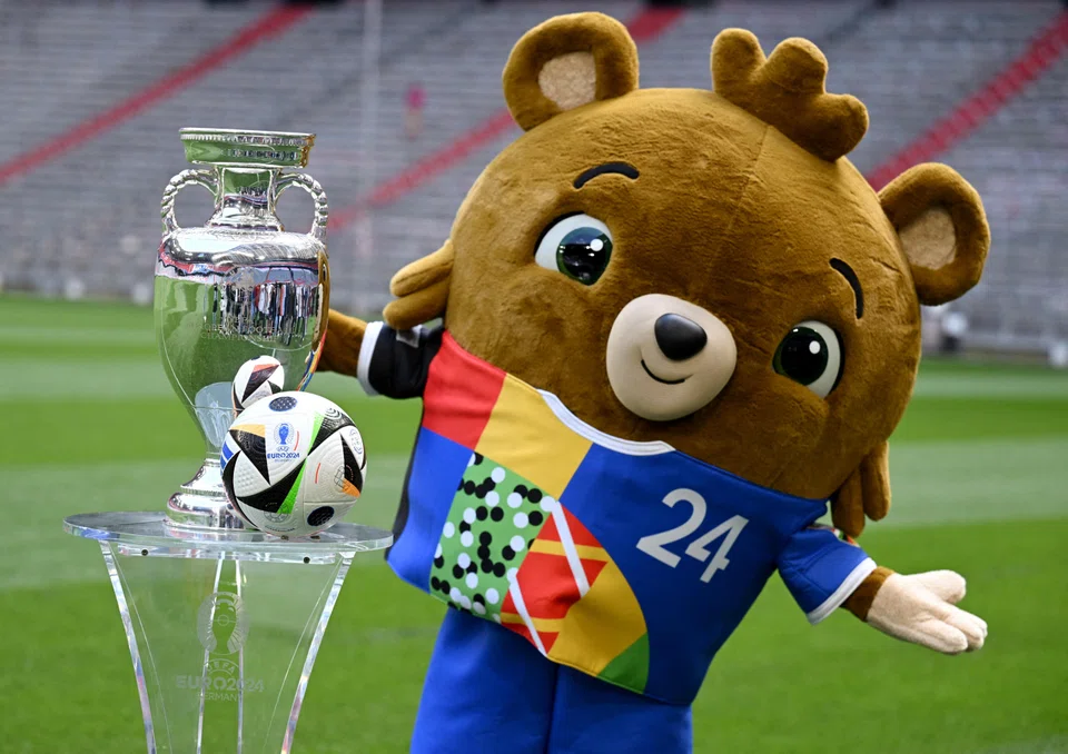 Euro 2024 mascot Albart poses with the European Championship trophy in Germany. The 24-team tournament begins on June 14.