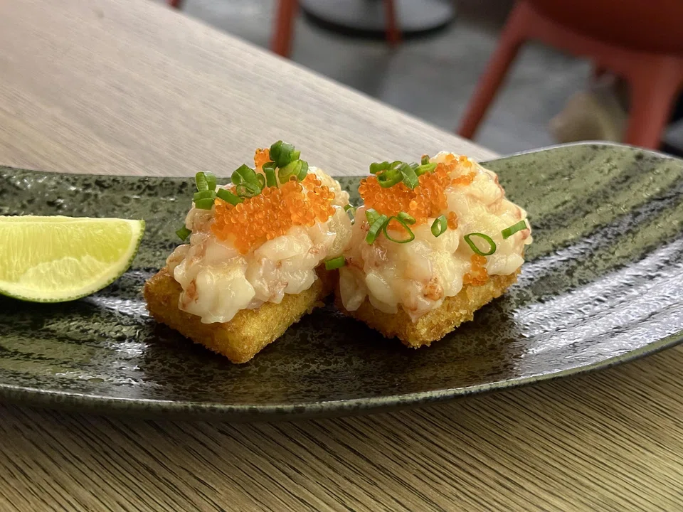 "Sushi" of fried rice cake topped with prawn tartare.