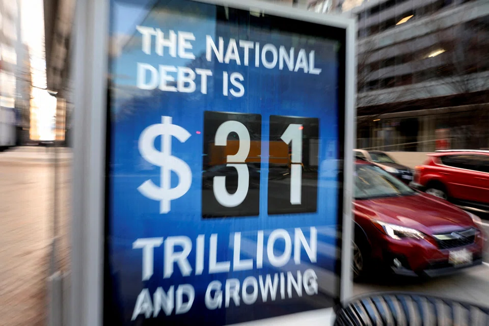 A board at a bus stop in Washington showing the US national debt figure after the US government hit its US$31.4 trillion borrowing limit on Jan 19 amid a standoff between the Republican-controlled House of Representatives, President Joe Biden and Democratic legislators that could lead to a fiscal crisis in a few months.