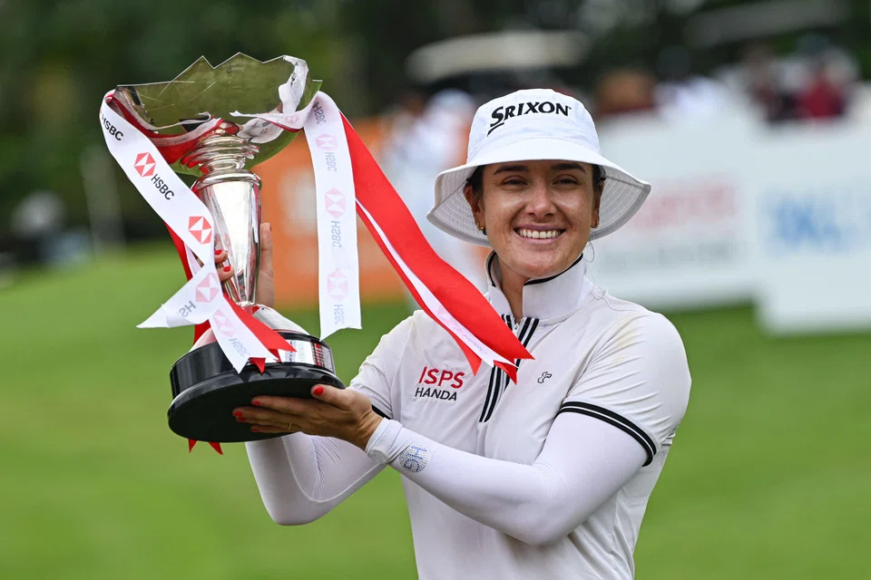 Hannah Green of Australia lifts the trophy after winning the final round of the HSBC Women's World Championship golf tournament at Sentosa Golf Club in Singapore on Sunday.