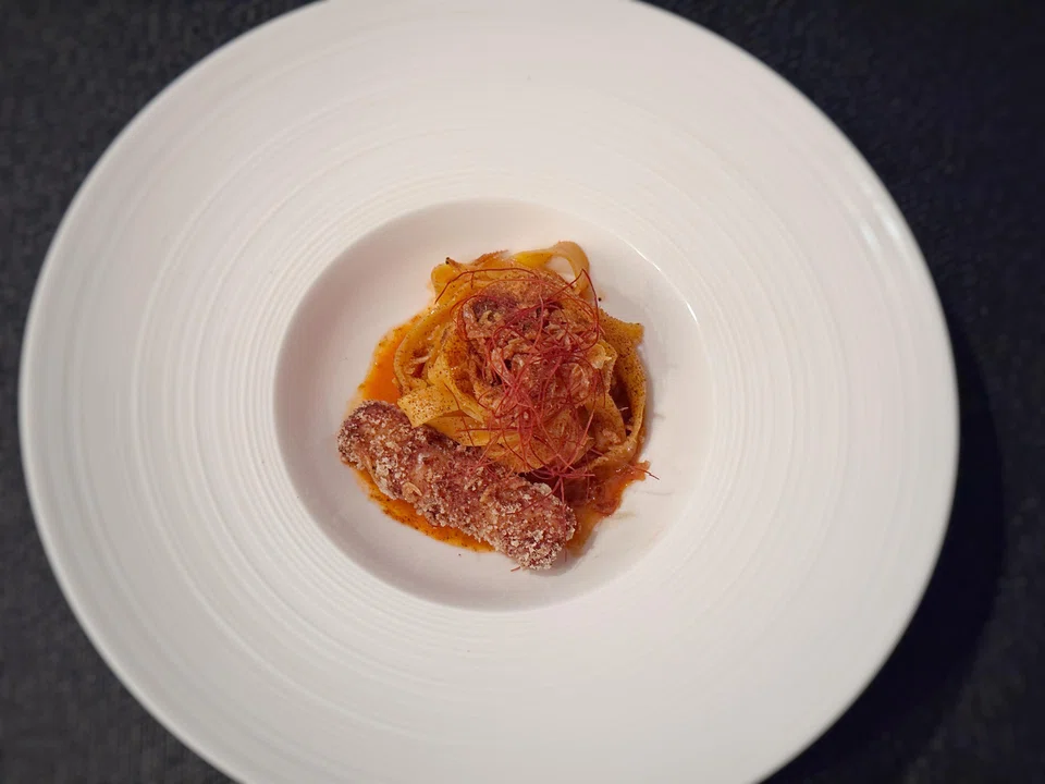 Homemade pasta is dressed in an intense prawn sauce made of carabinero heads and dried shrimp.