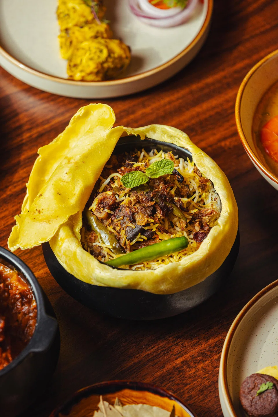 Gosht biryani comprises spiced lamb and basmati rice.