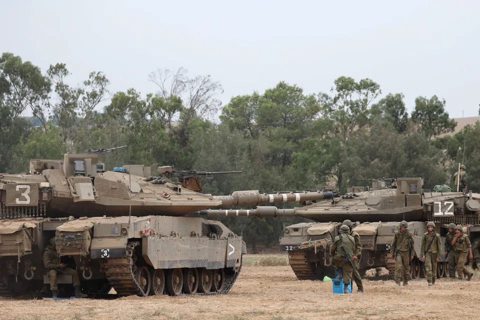 Israeli army soldiers are positioned near the border with the Gaza Strip in southern Israel. A dozen Thai nationals were killed, nine wounded and 11 more kidnapped when Hamas militants burst across the fence from Gaza on a rampage that killed at least 700 Israelis.