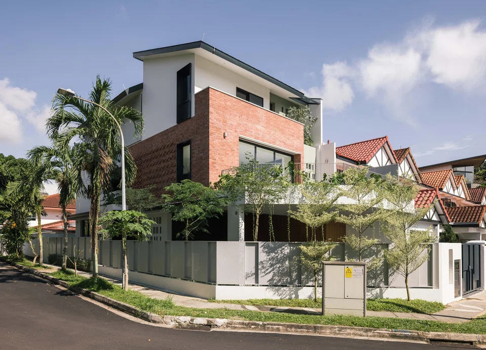 The facade is a collage of features and openings, while the boundary wall and side gate are made of perforated sheets that provide visual connectivity to the street.
