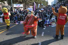 A man wearing a fat suit and a mask depicting South Korea's President Yoon Suk-yeol dances during a protest calling for Yoon's ouster outside the National Assembly in Seoul.