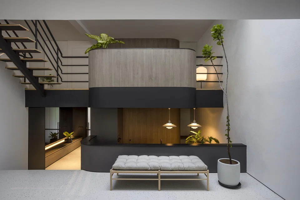 Studio iF retained the atrium’s glass skylight, timber staircase and black steel pipe railings.