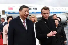 French President Emmanuel Macron welcomes Chinese President Xi Jinping, at the Tarbes-Lourdes Pyrenees airport.
