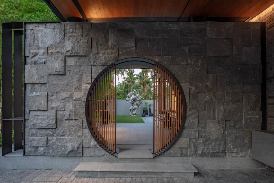The moon gate frames the garden’s focal point, a 3,000kg scholar’s rock that was imported from China. 