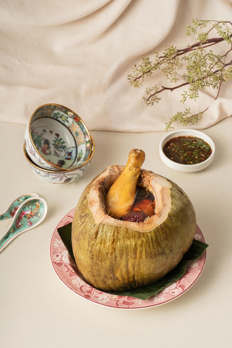 Nourishing chicken consomme served in a whole coconut.