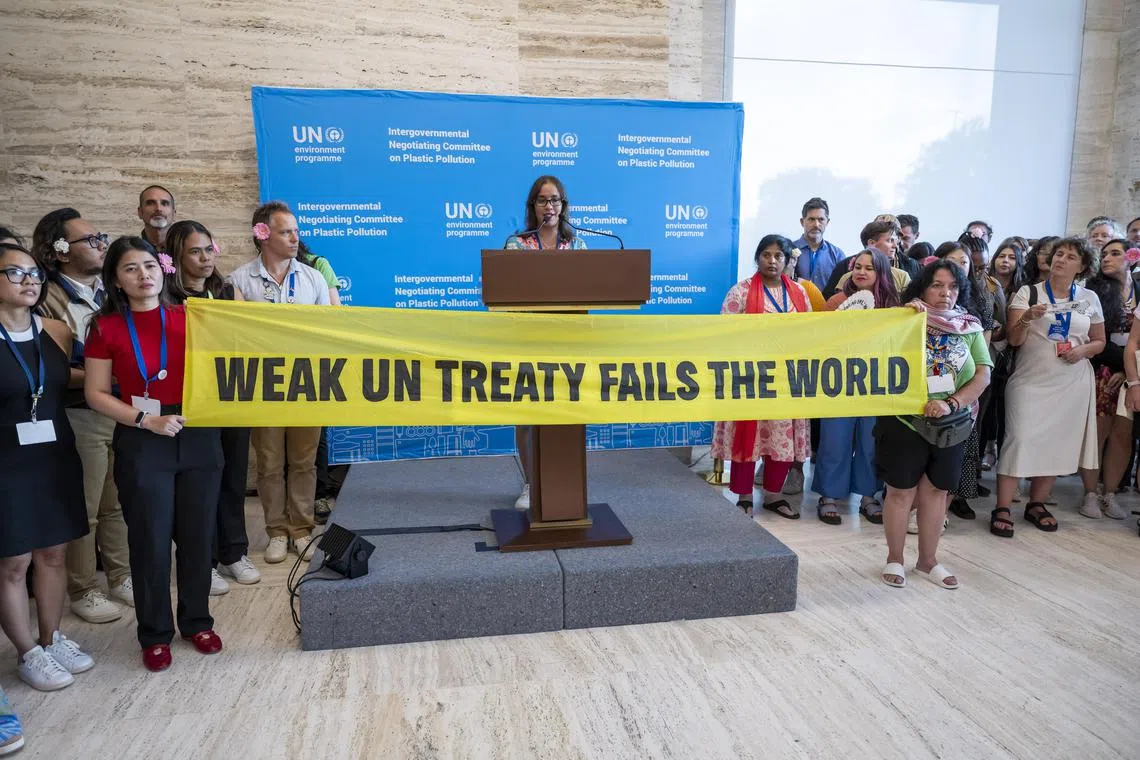 Activists stage a protest during the last day of the Second Part of the Fifth Session of the Intergovernmental Negotiating Committee on Plastic Pollution (INC-5.2), Geneva, Switzerland, Aug 14, 2025.  