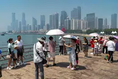 Pedestrians in Qingdao, China. Two-thirds of the global digital economy – will be powered by the US and China. 