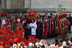 Priests decked out in choir dress and others in cassocks made up the long procession, some with candles in their hands, as groups of nuns followed behind. 
