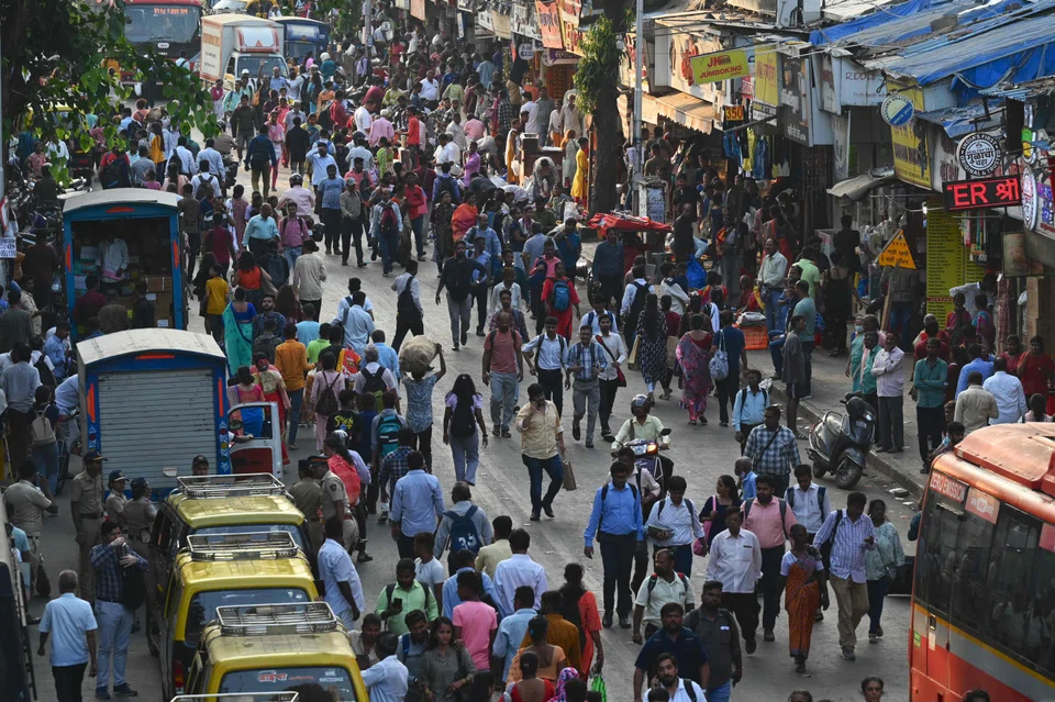 Commuters outside a railway station in Mumbai, April 2023.