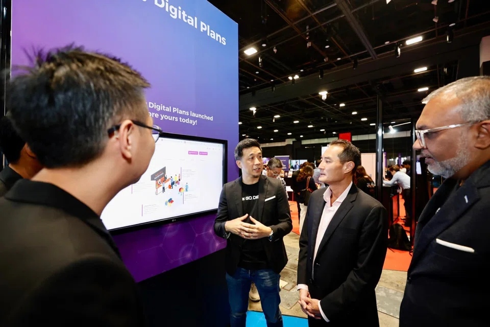 Senior Minister of State for Digital Development and Information Tan Kiat How (second from right) notes that the effective use of AI will allow SMEs to punch above their weight. 