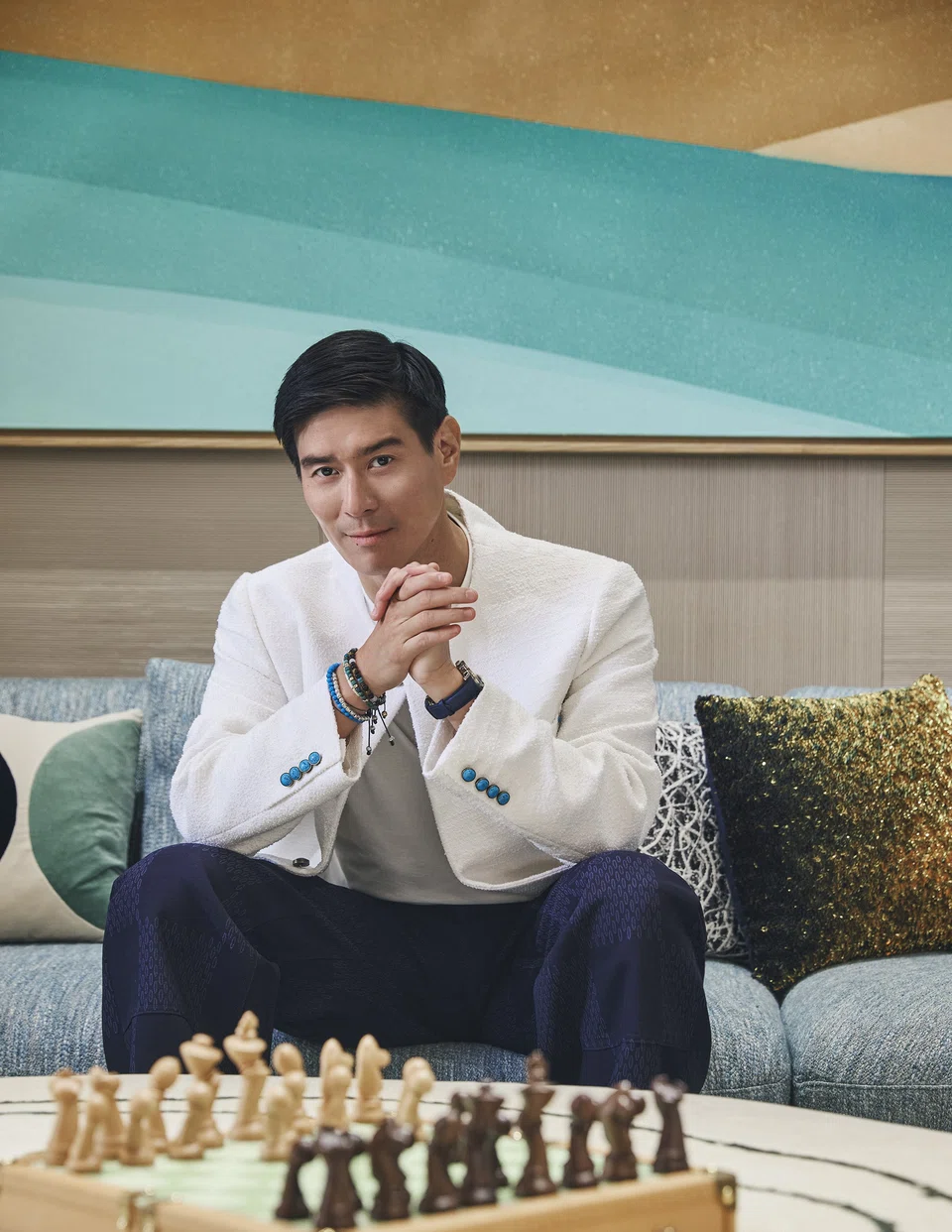 Evan Kwee has many hotel openings in the pipeline. He wears a white T-shirt, off-white cardigan, navy blue trousers and Escale Worldtime watch, all from Louis Vuitton. 