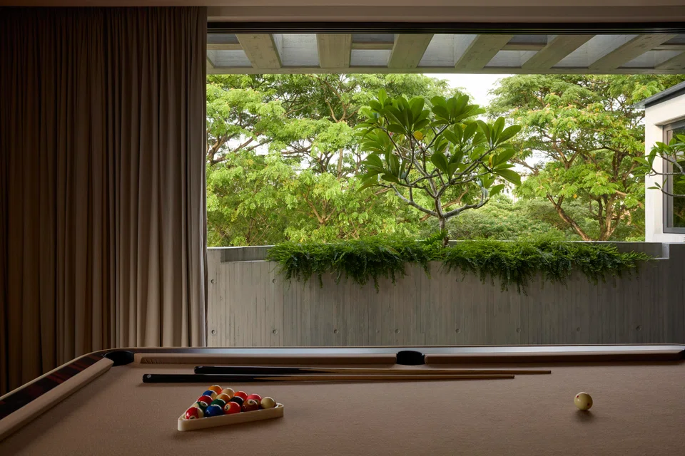 The attic entertainment room looks out to the tree canopy of the public car park. 