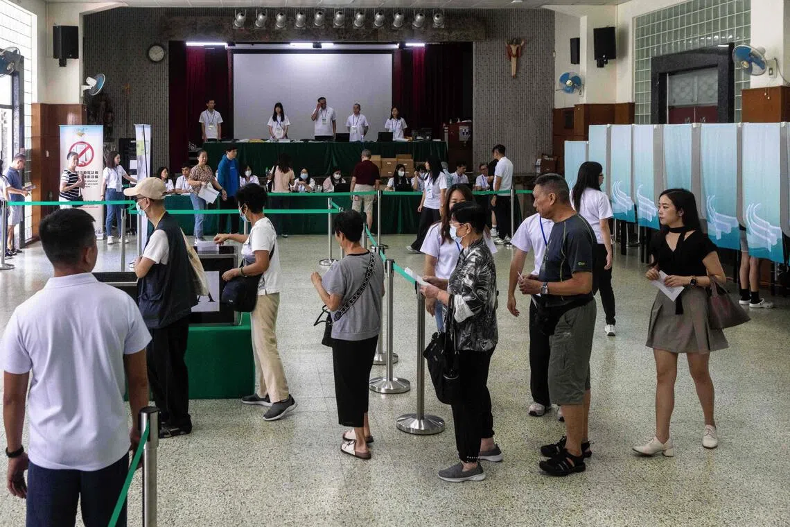 People queue to cast their ballots at a polling station in Macau, Sep 14, 2025. 