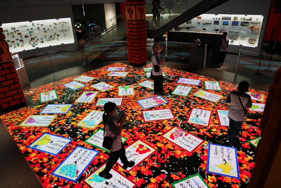 People interacting with an exhibit at the Nintendo museum, Kyoto, Japan, Sept 25, 2024. 