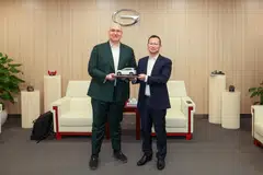 Philipp Kandal, chief product officer at Grab, with Xia Xianqing, president of GAC.