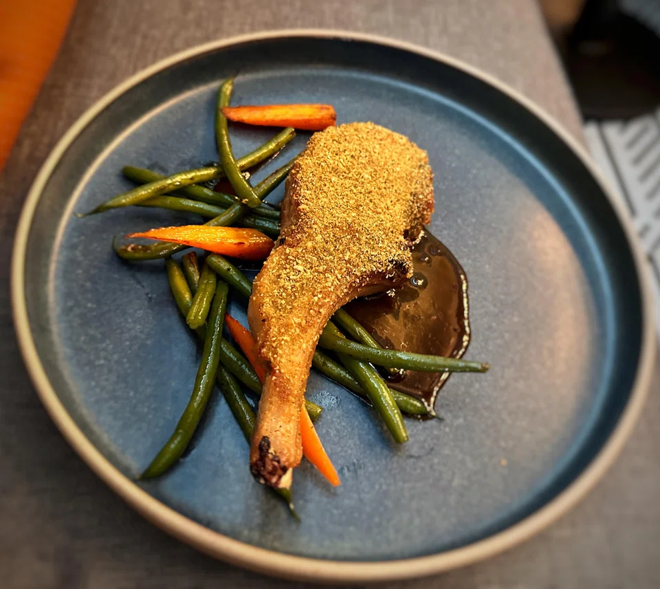 A grilled Duroc pork chop is meaty and juicy with a gingery crumb crust. 