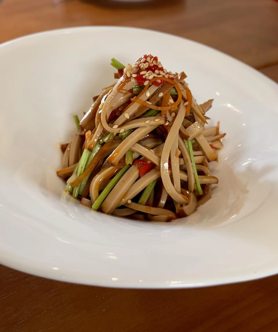 Bouncy egg strips are tossed in a spicy dressing in the egg curd salad.