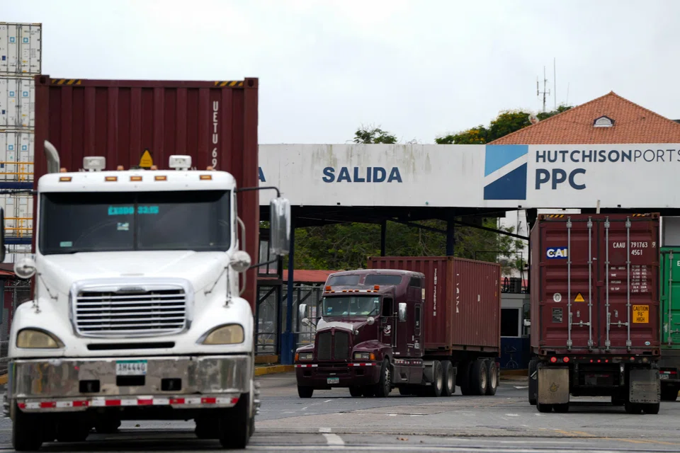 Container trucks leave Panama Ports Company in Panama City on Feb 4. CK Hutchison’s plan to net more than US$19 billion in cash for a group of 43 ports has faced repeated setbacks.