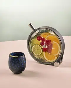 In Full Bloom, one of the signature cocktails at botanical-themed Ginger.Lily, is served in a clear infuser that displays a mix of fruit and herbs.