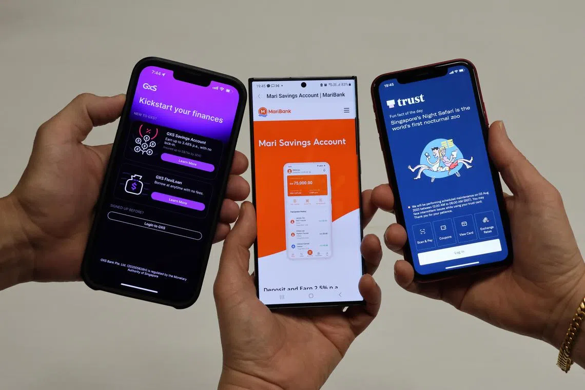 From left: Phone apps of GXS bank, Maribank and Trust Bank. Of the three digital banks, GXS and MariBank are a long way from meeting capital targets required to become full-fledged digital retail banks.