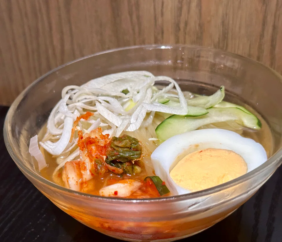 Thick noodles in a cold kimch-flavoured broth.