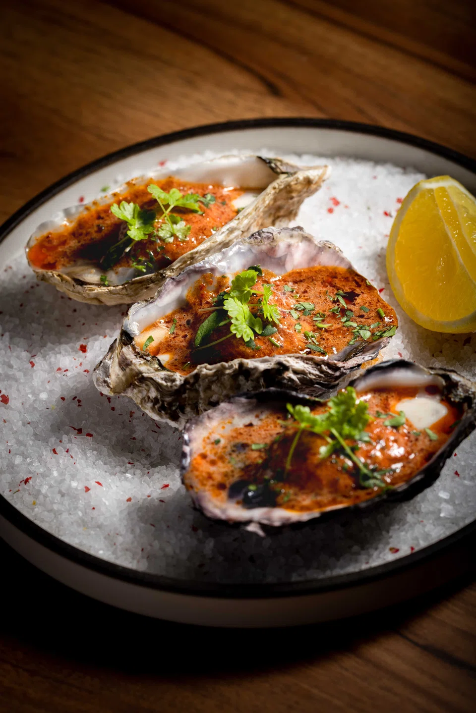 Grilled oysters in chipotle bourbon butter sauce