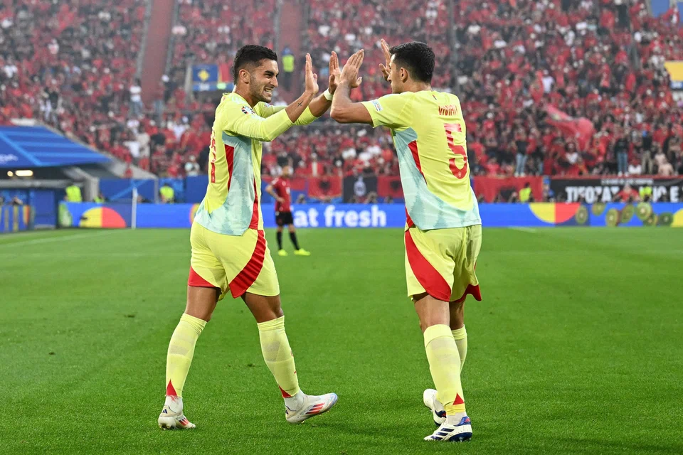Spain forward Ferran Torres (left) celebrating with defender Daniel Vivian after scoring his team's only goal against Albania.
