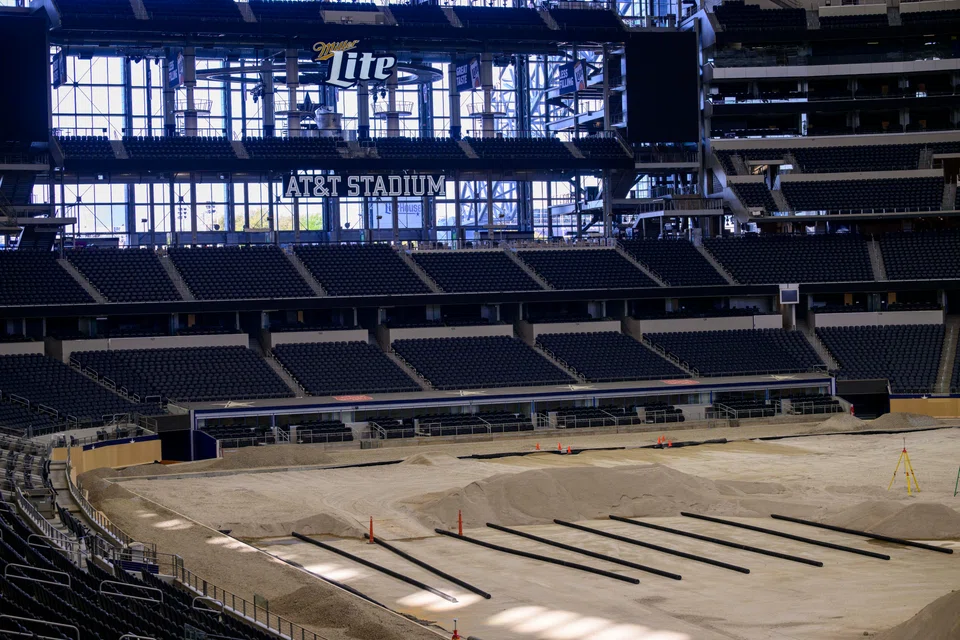 The interior of AT&T Stadium in Arlington, Texas, as work crews prepare the playing field for the World Cup. Tourism and hospitality leaders in the 11 US host cities are watching international fans closely.