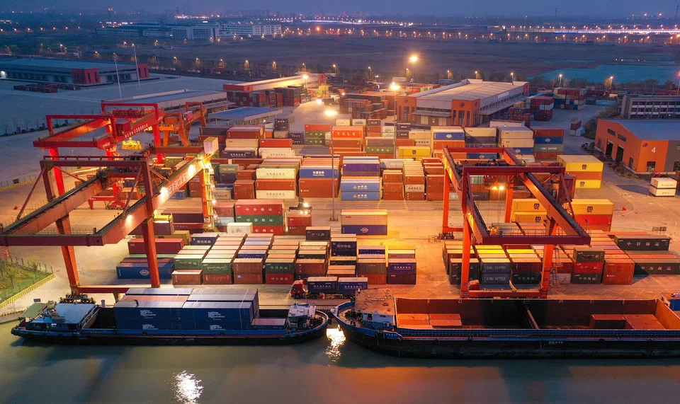 Cargo ships berthing at Suqian port in China's eastern Jiangsu province. The container pile-up in China is one of the more visible symptoms of the problems in the shipping industry.